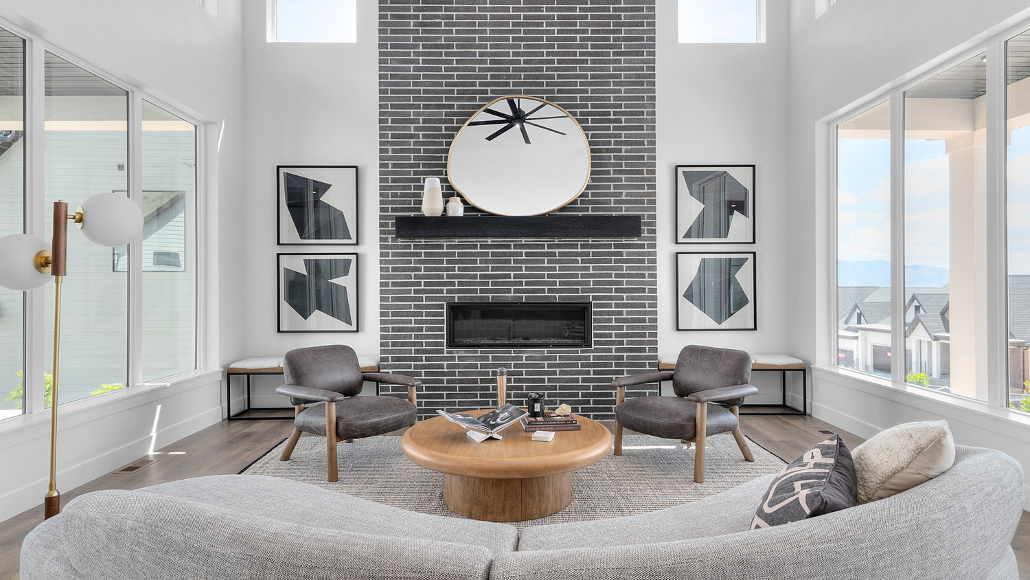 Living room with fireplace and lots of windows.