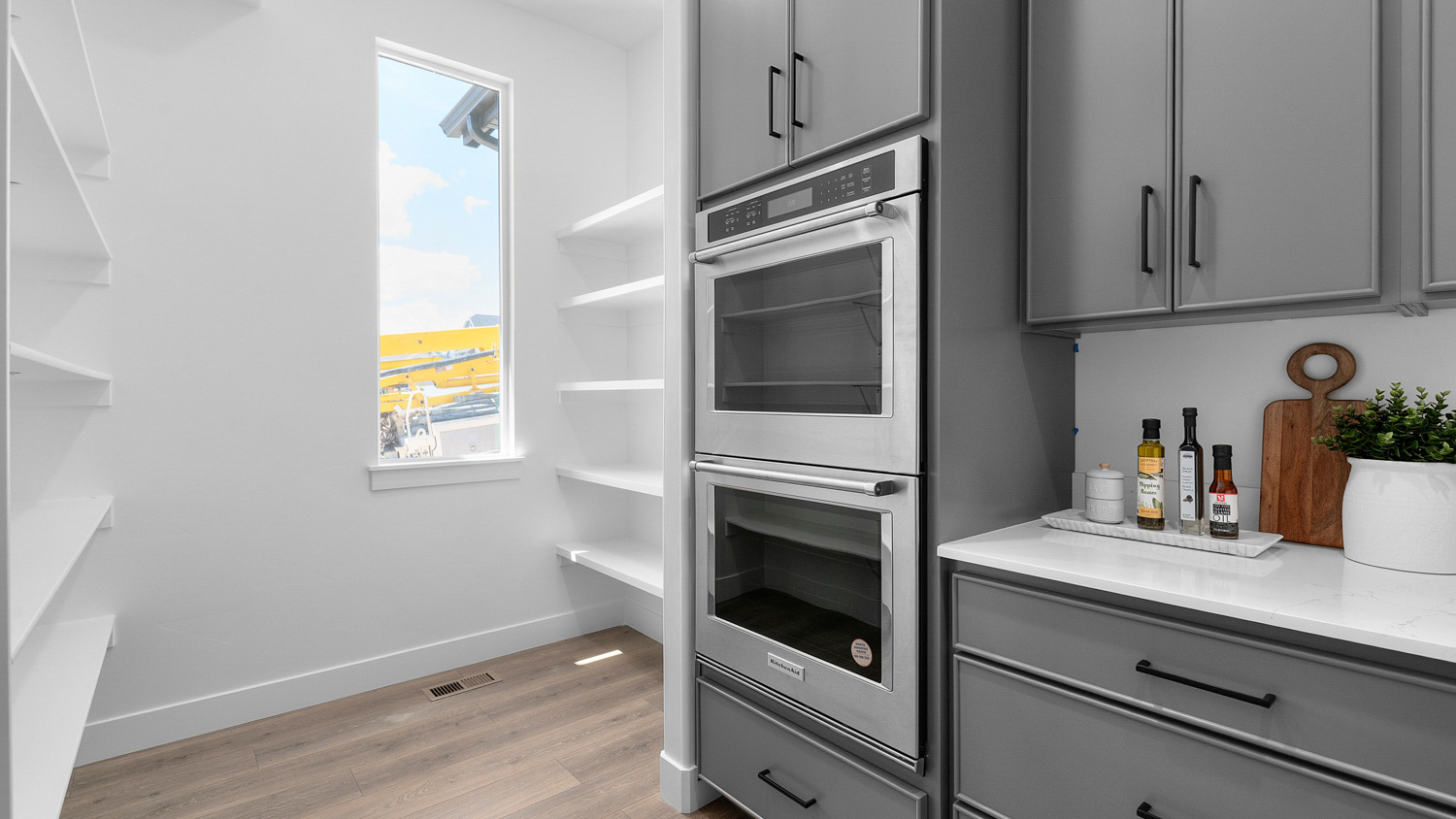 Butler pantry off the kitchen with double oven and pantry.