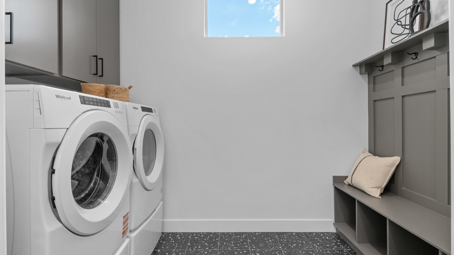 Laundry room with window and mudroom bench.