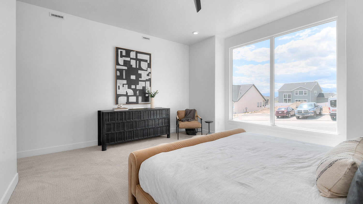 Another view of primary bedroom with large window.