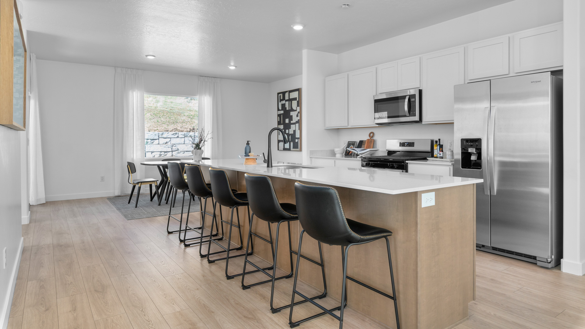 Kitchen with large kitchen island and stainless steel appliances.