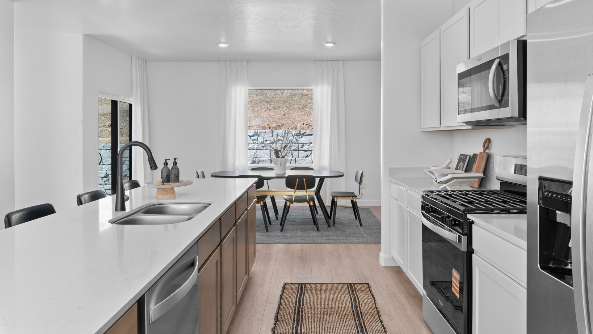 Kitchen with large kitchen island and stainless steel appliances.