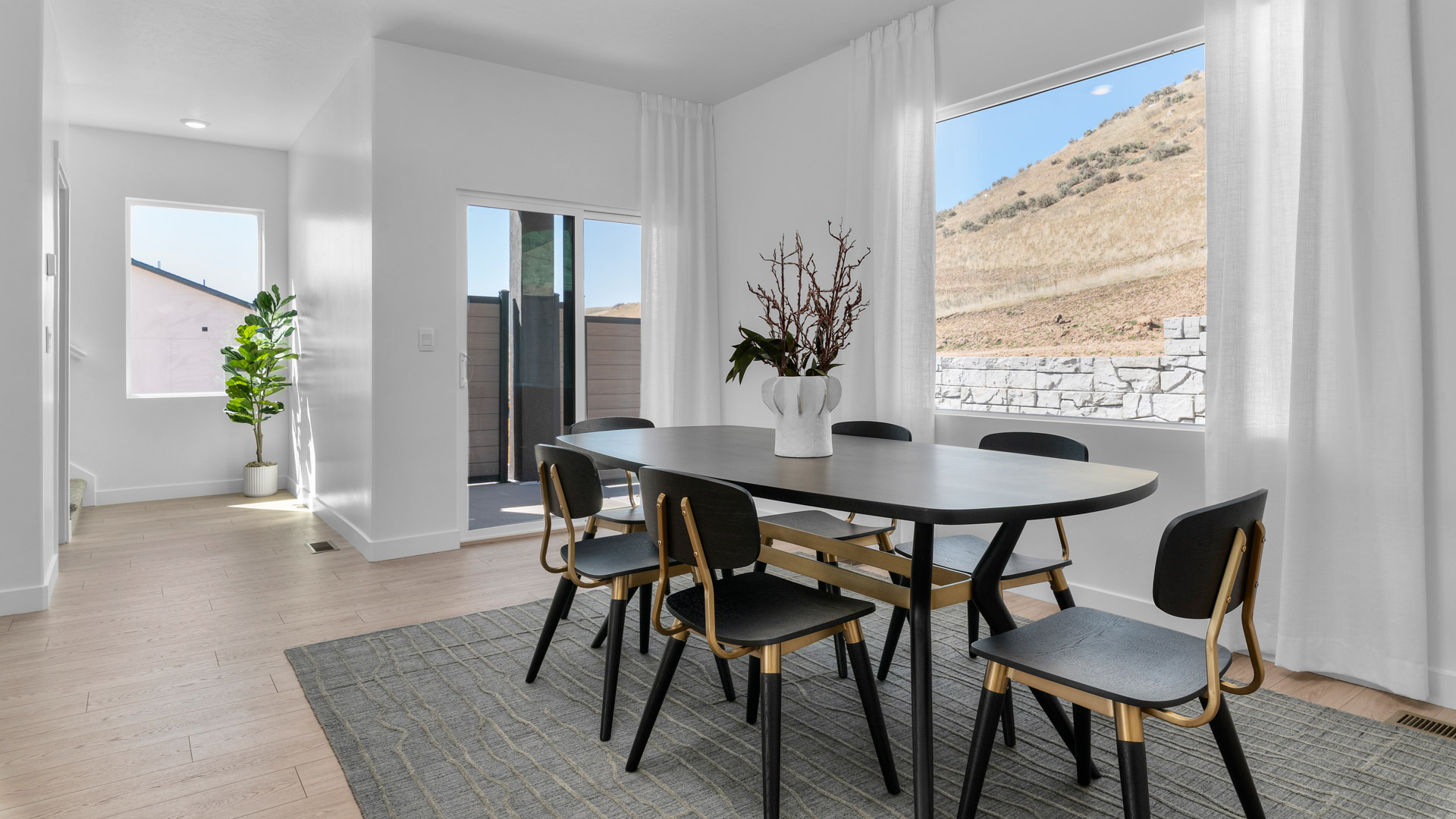 Dining room with large window and patio doors.