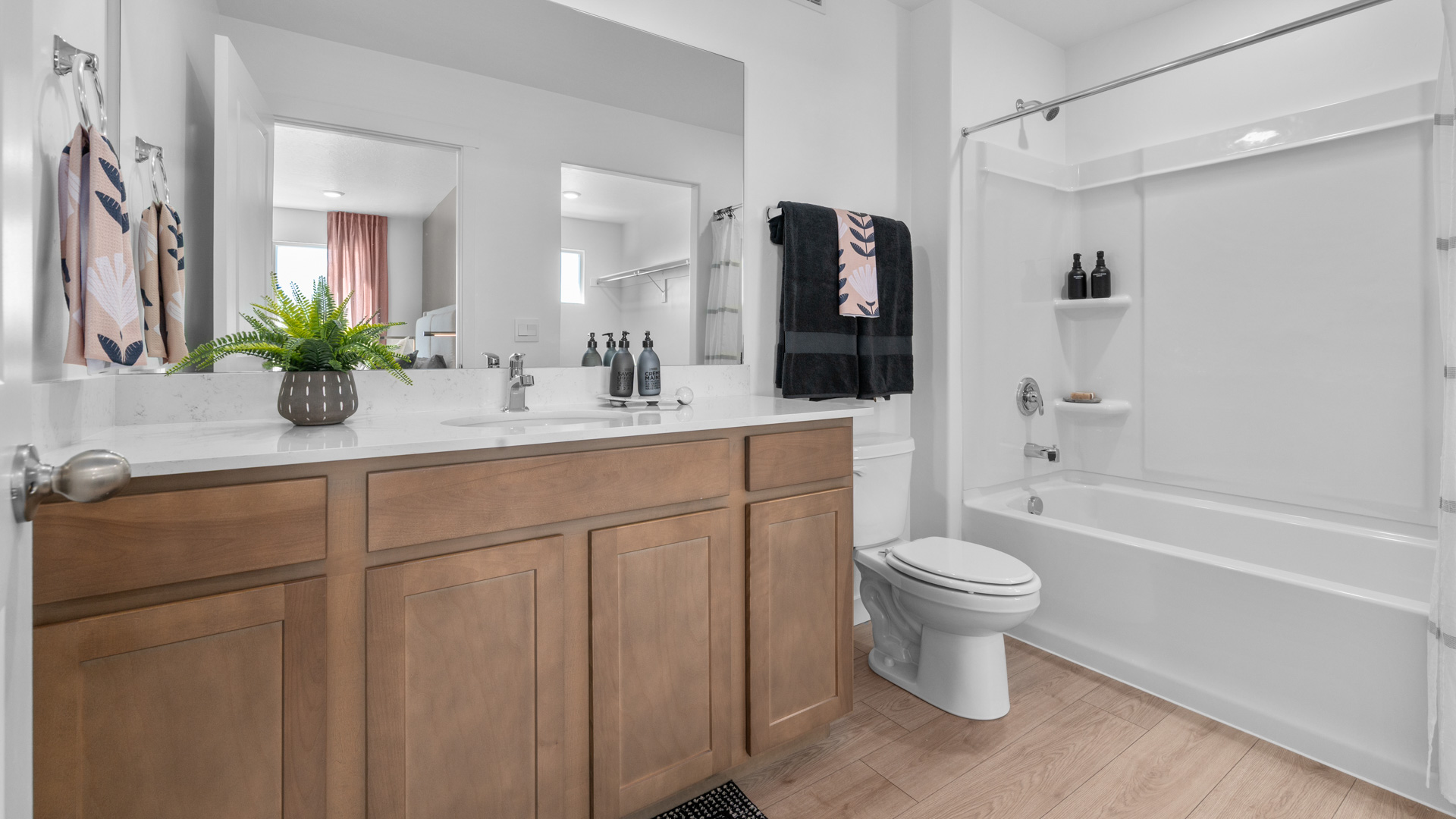 Bathroom with large vanity and shower surround.