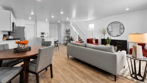 Look from entryway into main living space featuring living room and kitchen.