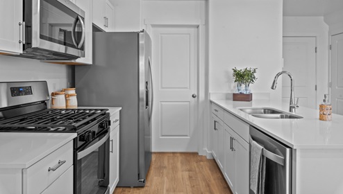 Kitchen space near peninsula and white kitchen cabinets.