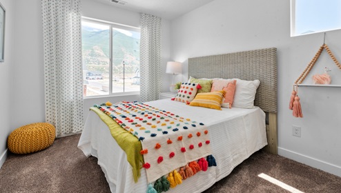 Large bedroom with window and square window.