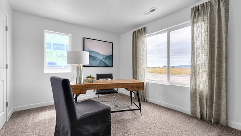 A stylish bedroom turned office at the Eagle Point Townhome community by D.R. Horton.