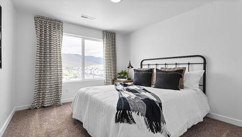 Stylish and spacious secondary bedroom with large window letting in a lot of light.