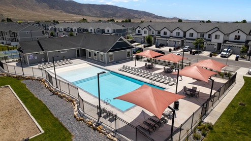 Pool and clubhouse at Eagle Point Townhomes community in Eagle Mountain Utah.