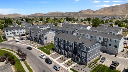 Aerial photo of D.R. Horton’s Eagle Point Townhomes community with club house and community pool.