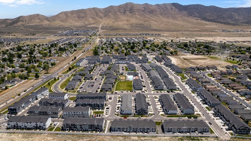 Aerial photo of D.R. Horton’s Eagle Point Townhomes community with club house and community pool.