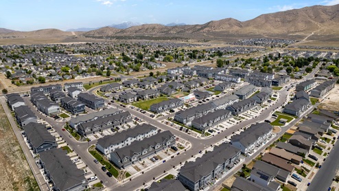 Aerial photo of D.R. Horton’s Eagle Point Townhomes community with club house and community pool.