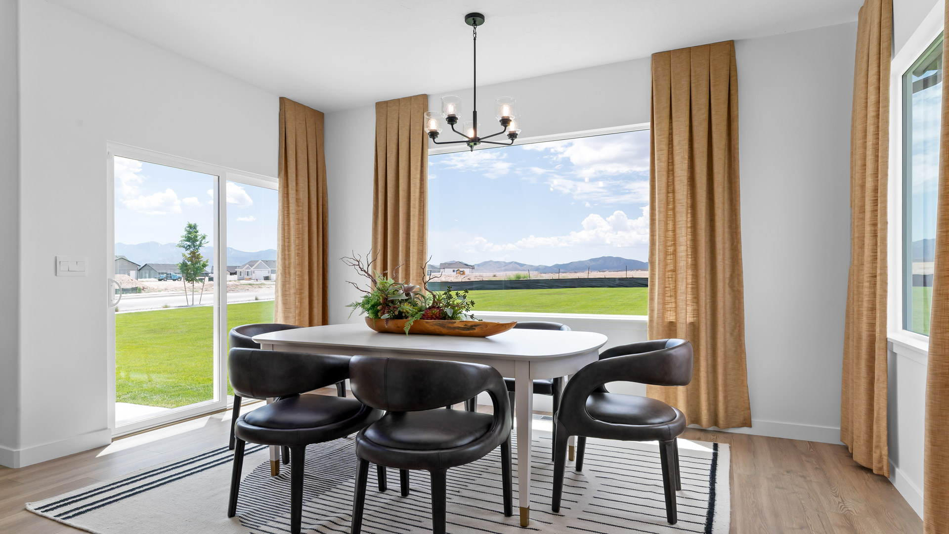 Dining room with patio doors and large windows.