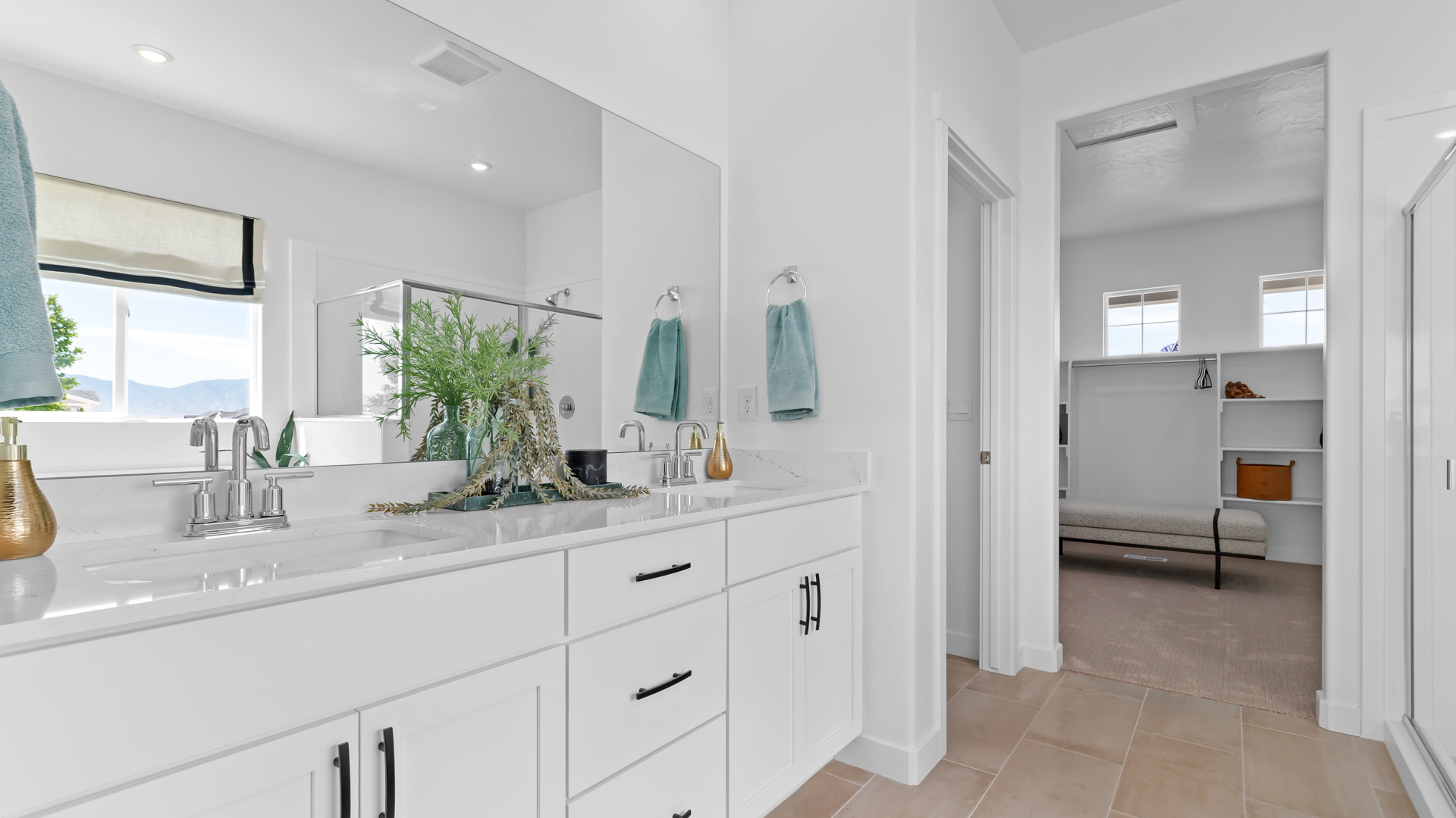 Primary bathroom with quartz countertops, dual sinks, water closet, walk in shower with glass door, and garden tub with large window above.