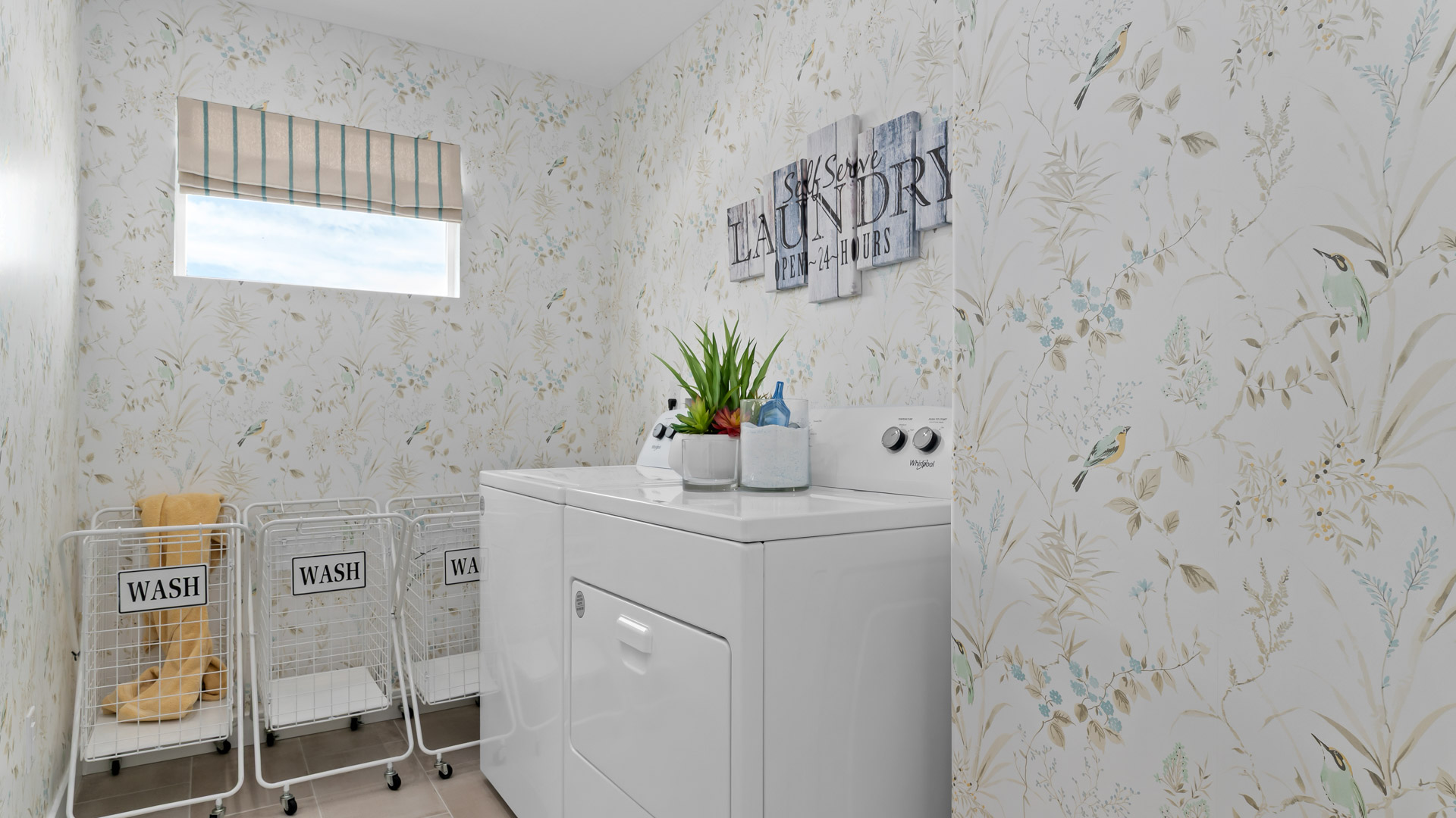 Laundry room with window and hard surface flooring