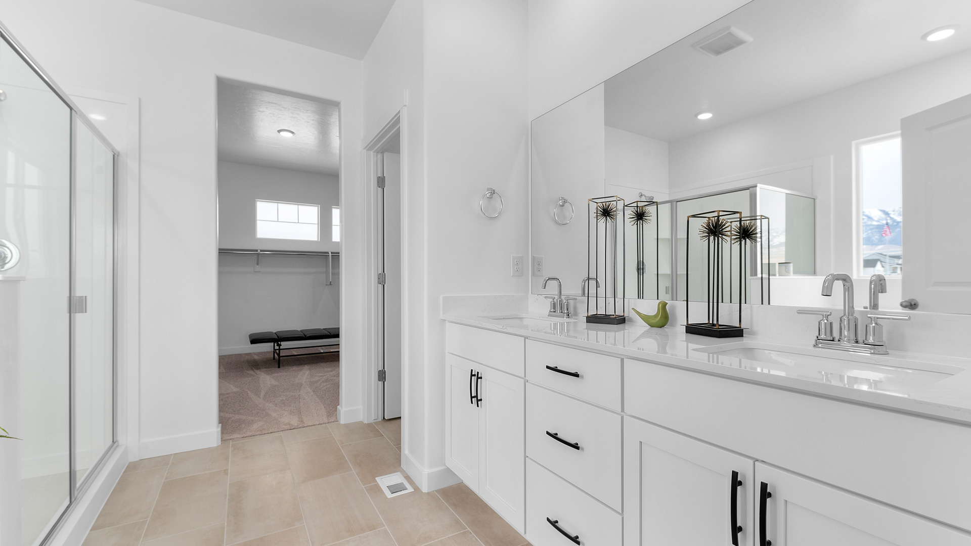 Primary bathroom with double sink vanity and bath and shower.