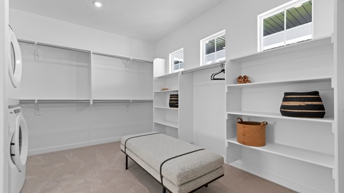 Large walk-in closet with windows.