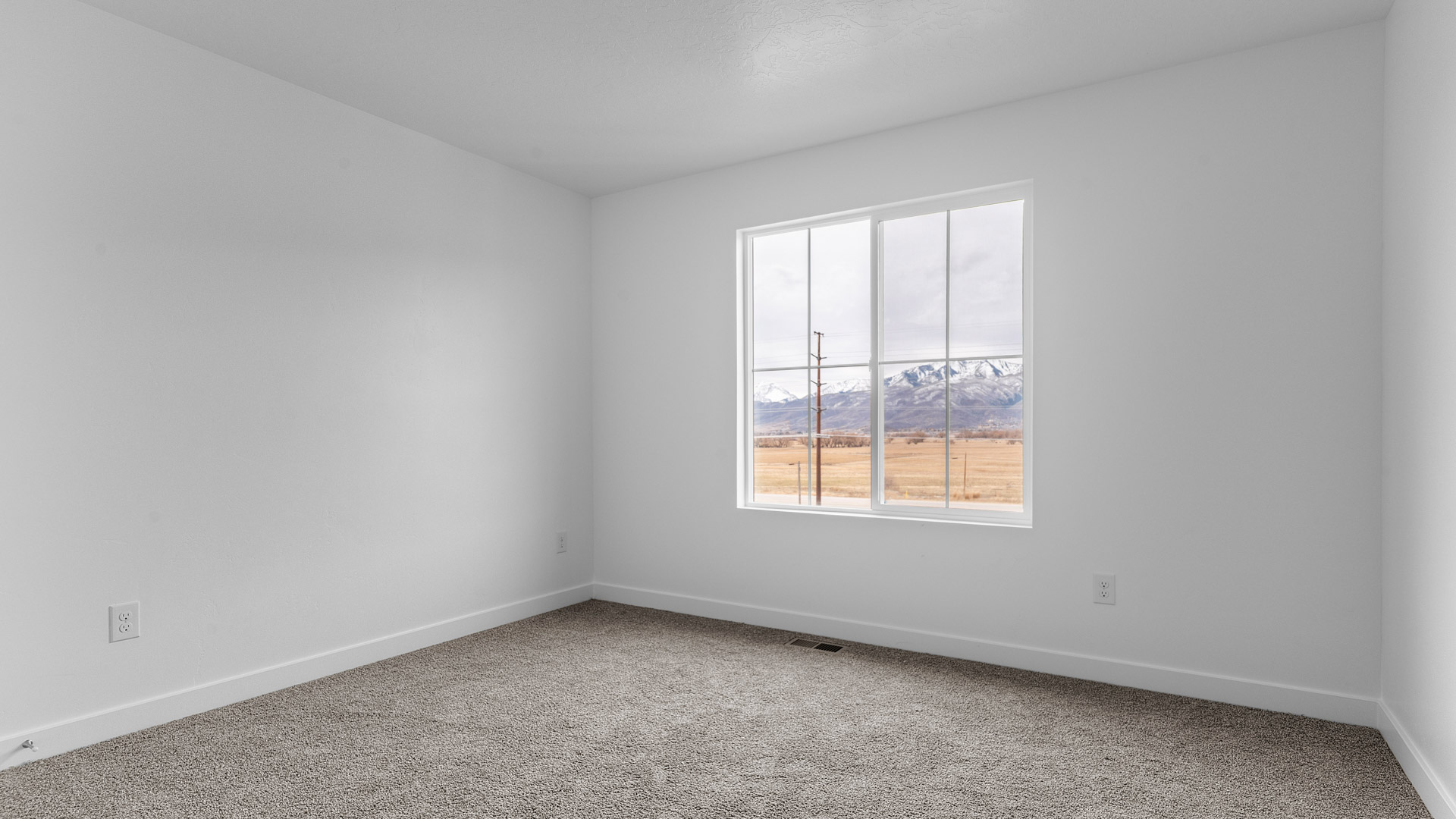 Primary bedroom with large window.