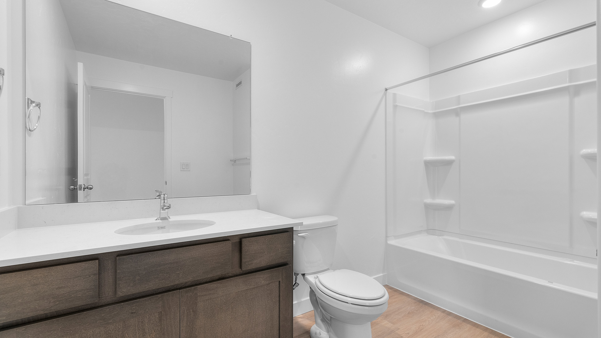 Bathroom with vanity and shower surround and window.