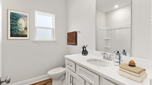 Sleek and spacious guest bathroom.