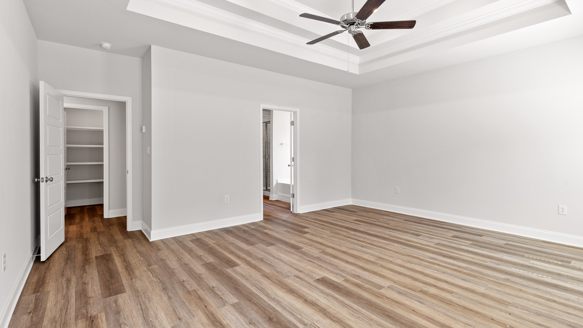 Spacious primary suite with entrance to laundry room