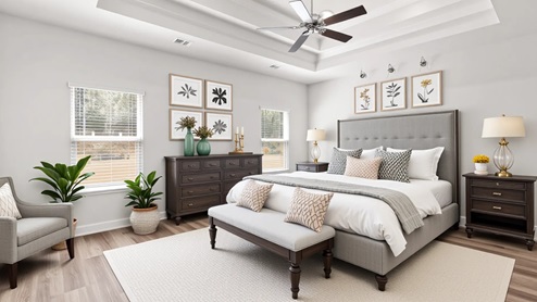 Luxurious primary suite with tray ceiling and fan in a new D.R. Horton Home.