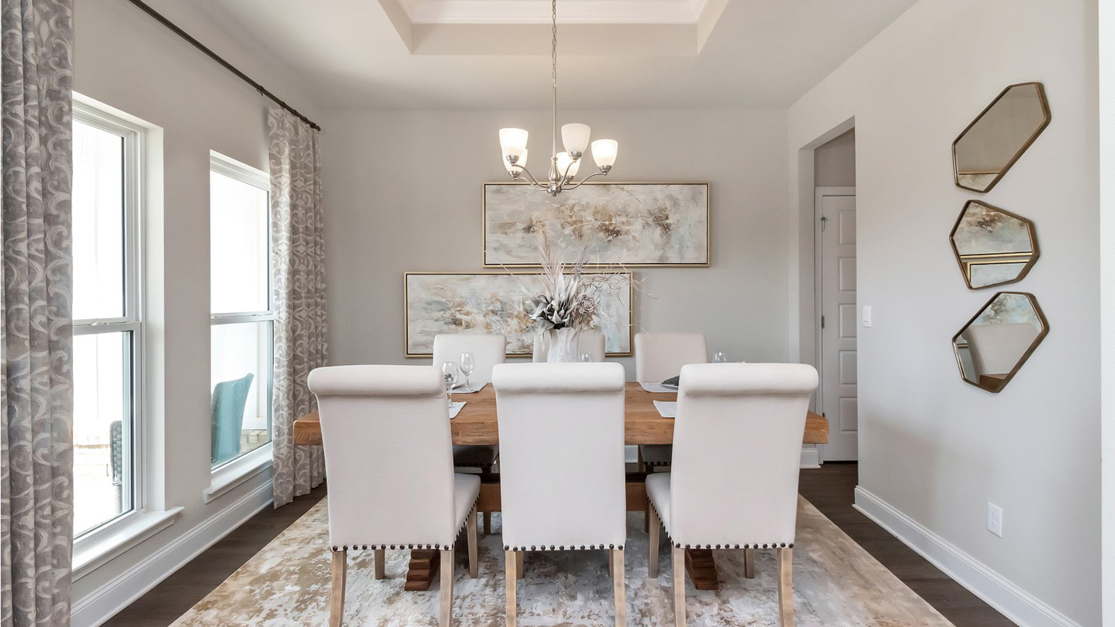 A bright dining space with modern lighting adds charm to this home on the Mississippi Gulf Coast.