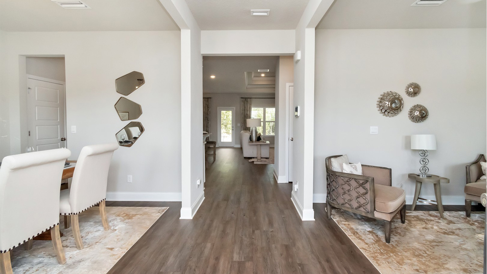 Luxury vinyl plank floors lead from the entry hallway into the heart of this Palm Pointe home.