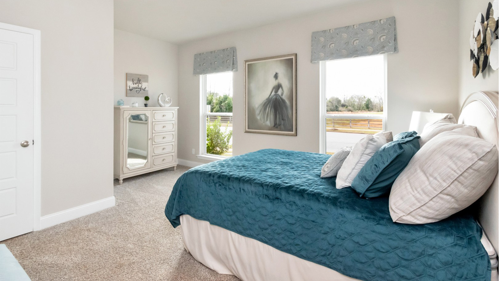 This cozy bedroom features soft carpet and generous natural light in the Katherine floorplan.