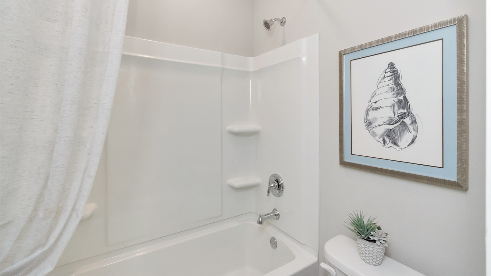 The guest bathroom offers a clean layout with a shower/tub combo in Palm Pointe.
