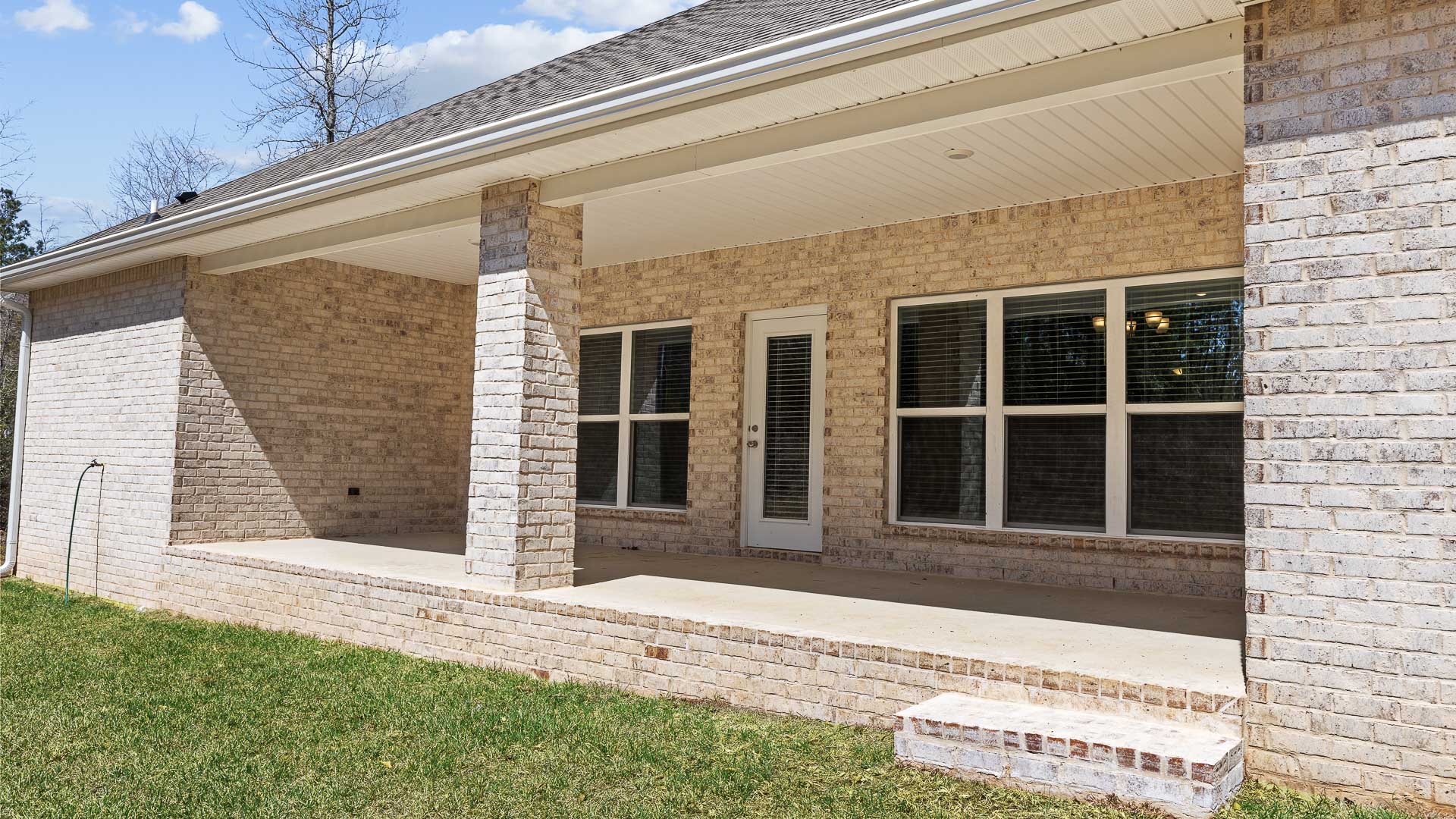 Covered back porch on a new home.