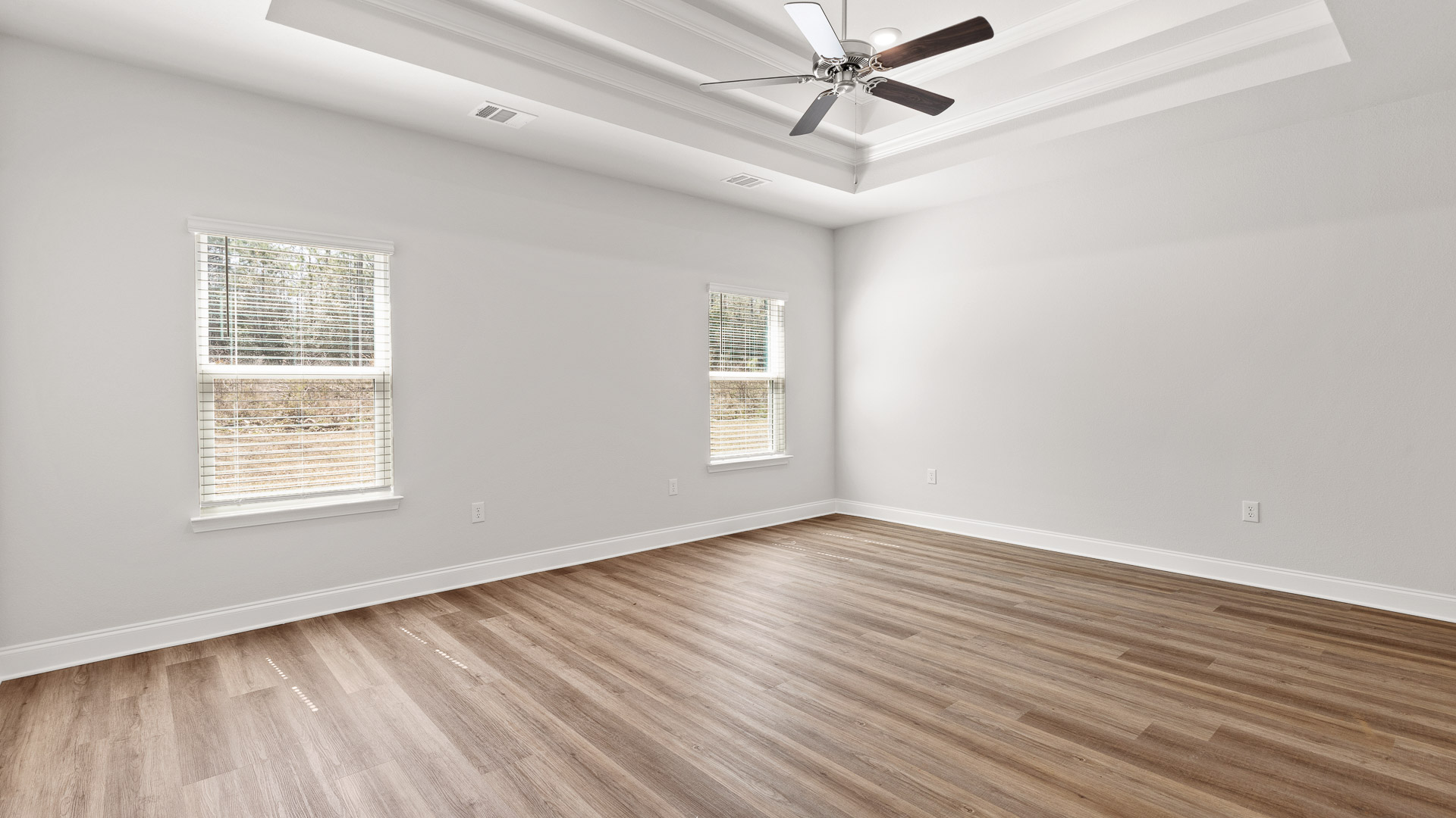 Primary bedroom in a new home by D.R. Horton.