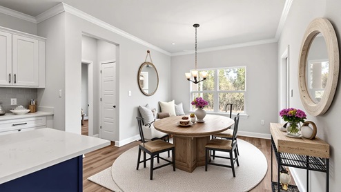 Breakfast nook with classic furnishings and chandelier off the kitchen in a new home in Palm Pointe.