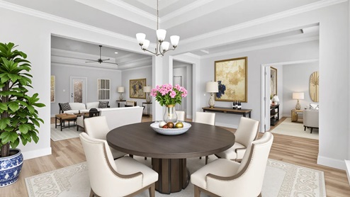 Formal dining room with circle table and chandelier in Palm Pointe.