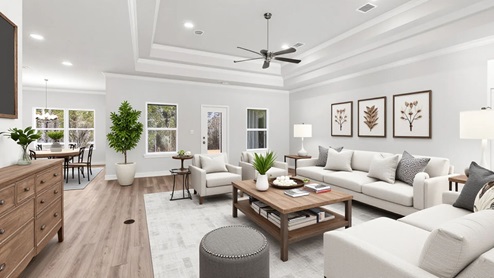 The Mila living area with farmhouse inspired furnishings in a new construction home.