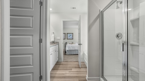Spacious and sleek primary bathroom suite
