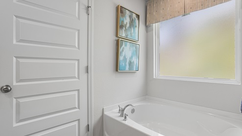 Bright and airy soaking tub.