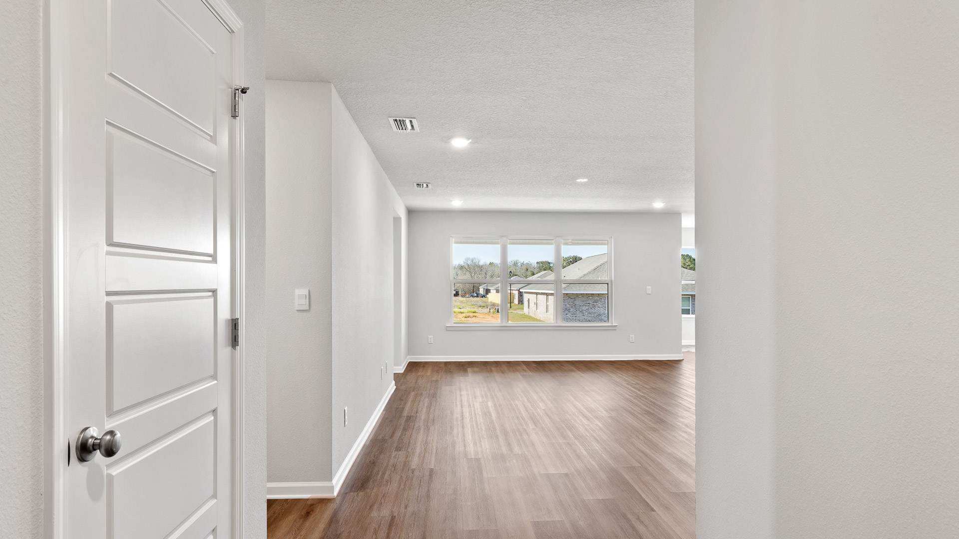 Open entry into the spacious living area in a new Booth floorplan in Biloxi.