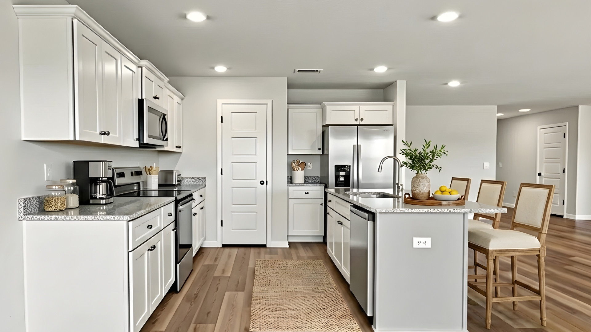 Kitchen with granite countertops and gray island.