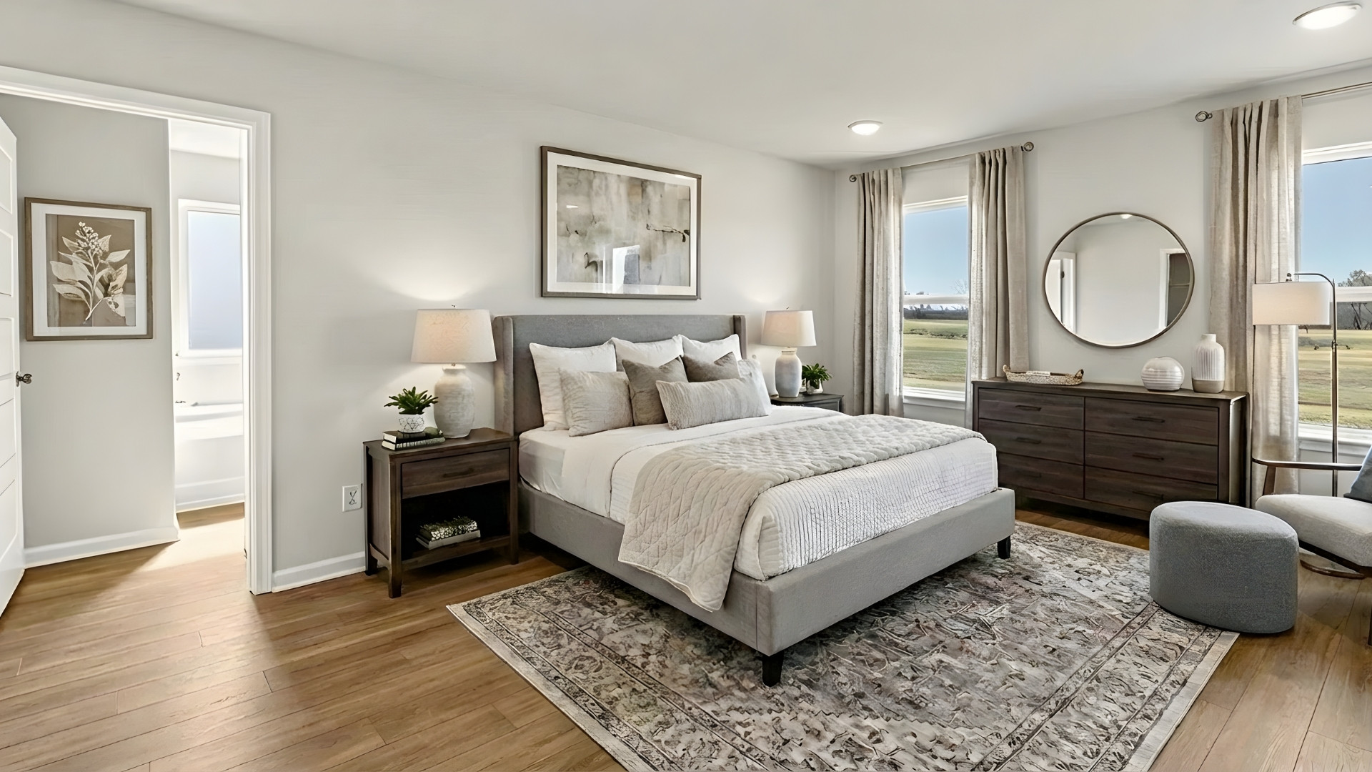 Primary bedroom with no carpet and neutral decor.