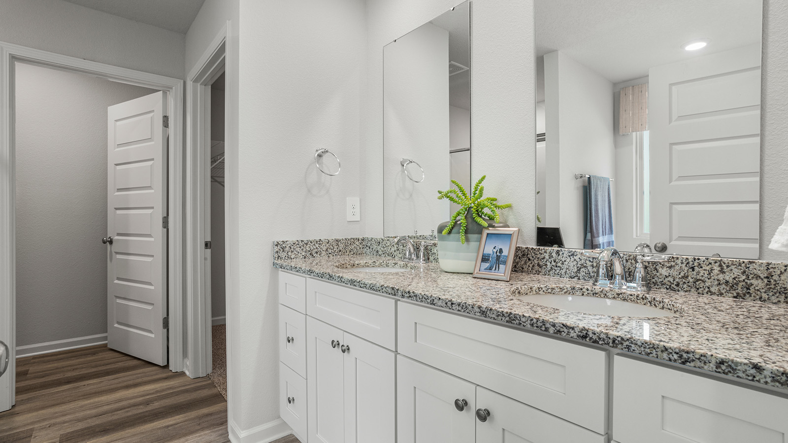 Spacious vanity area inside primary bathroom suite