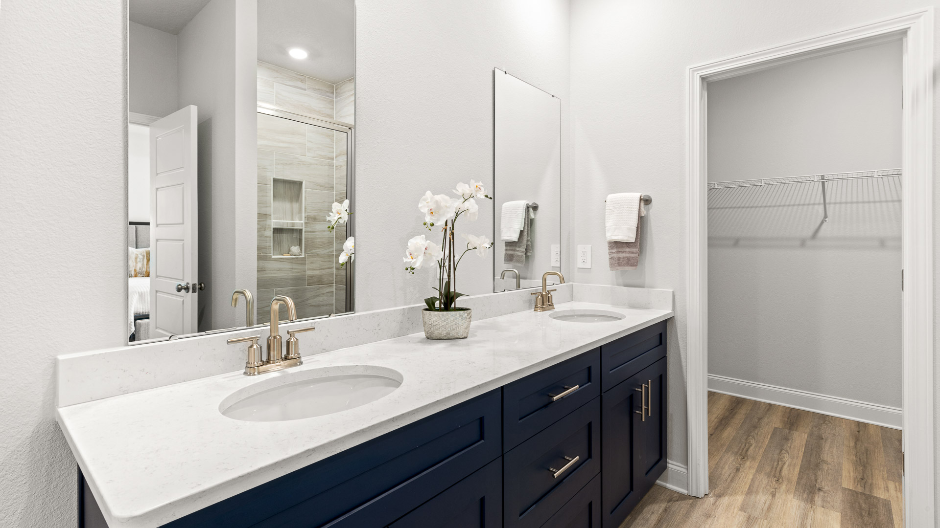 Primary bath, blue cabinets and white quartz.