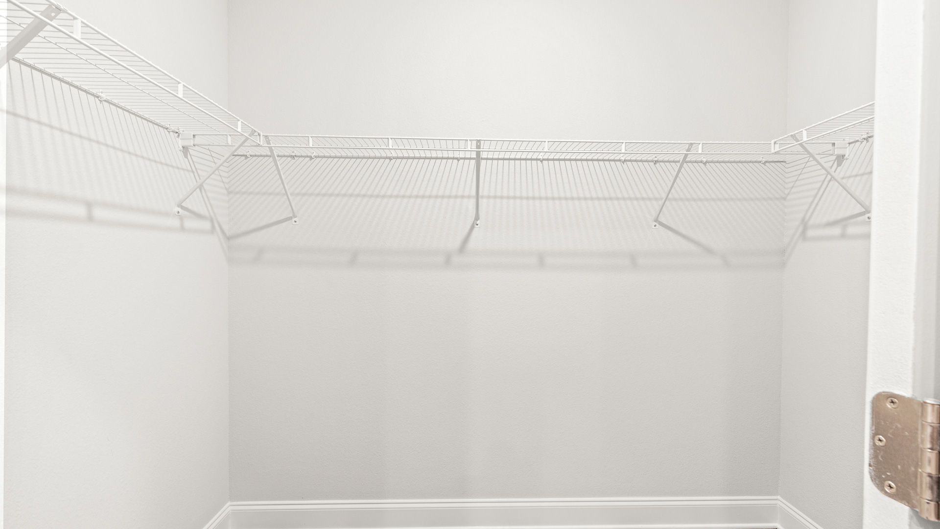 Spacious closet with lots of room for storage.