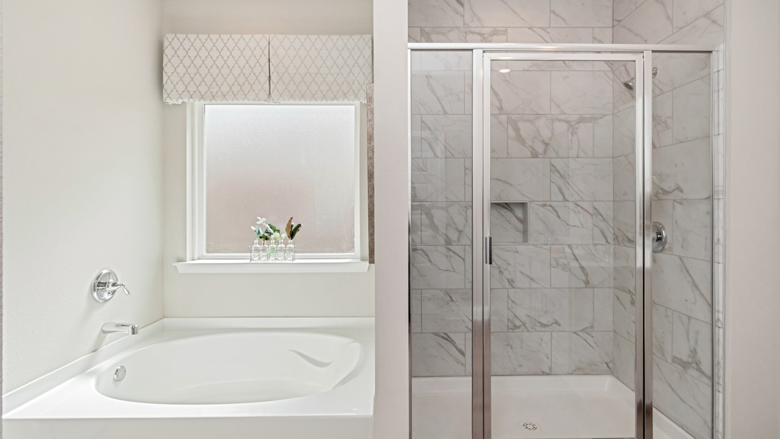 Tiled shower and soaker tub in a Rhett floorplan.
