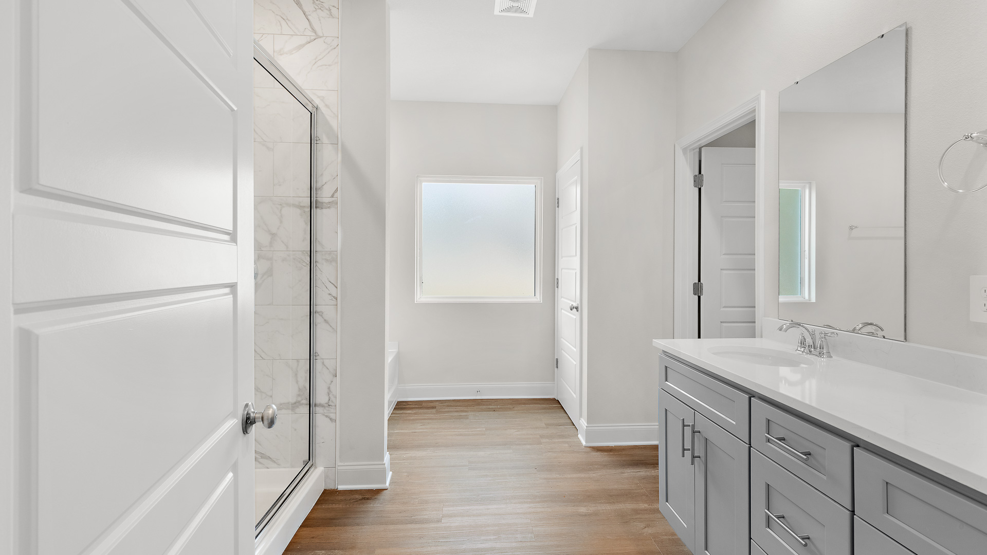 Spacious and sleek primary bathroom