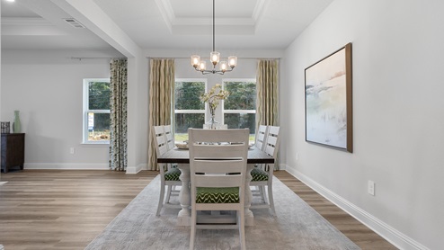 Side view of dining area by beautiful windows.