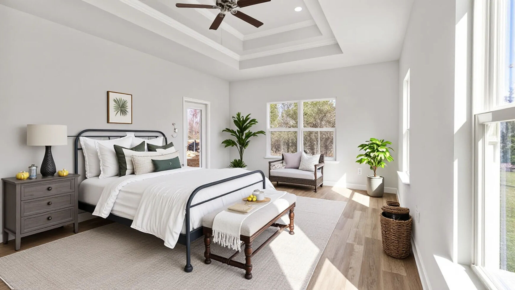 Spacious primary suite with tray ceiling and ceiling fan in South Mississippi.