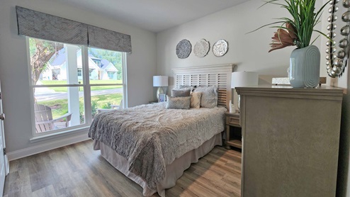 The Dover guest bedroom with large windows.