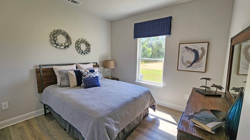 The Dover guest bedroom with large windows.